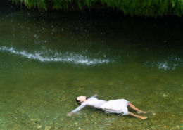 Woman floating on her back in lake